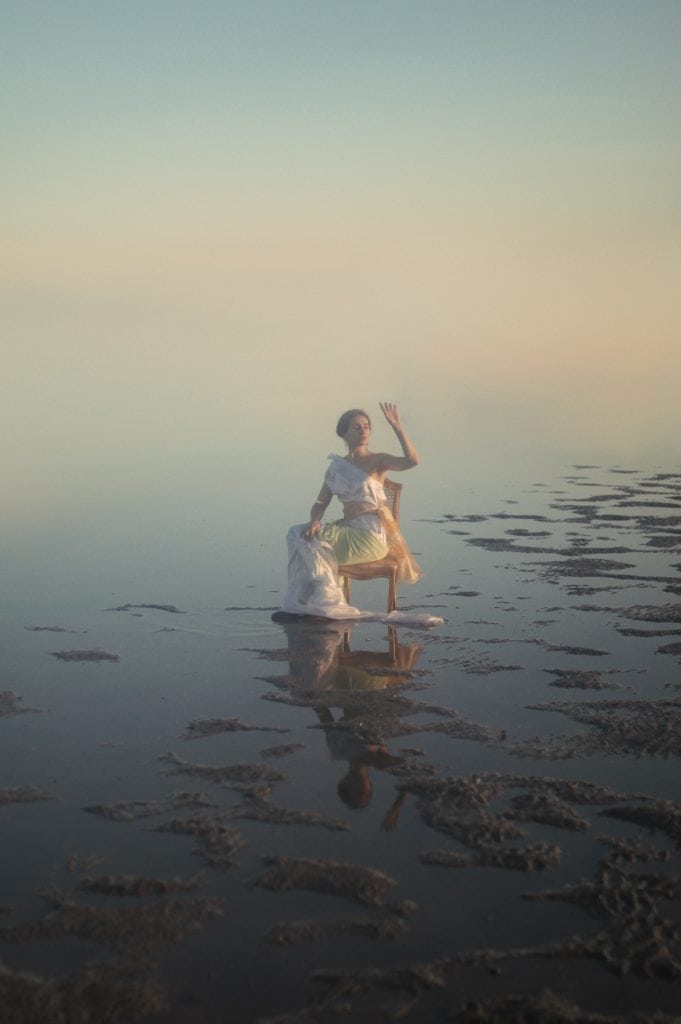 Greek girl sitting on river